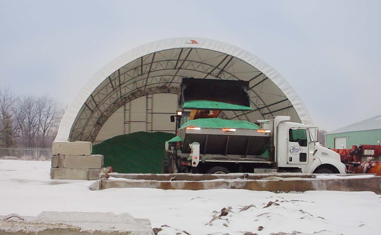 Sand and salt storage with dump truck and dozer