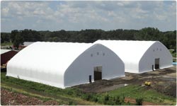 Two white fabric structures with shutters