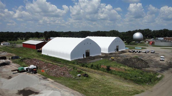 Two white fabric structures with shutters