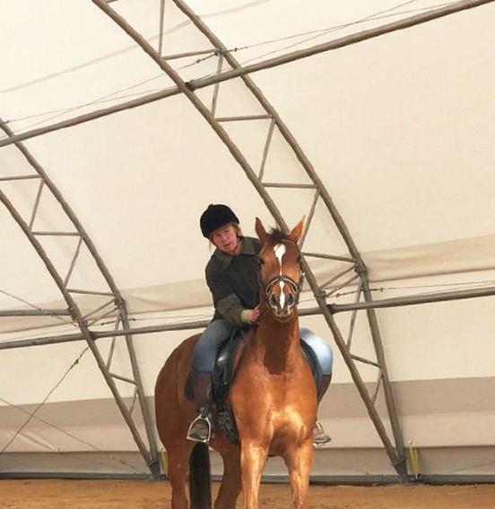 Lady Riding horse under a fabric structure