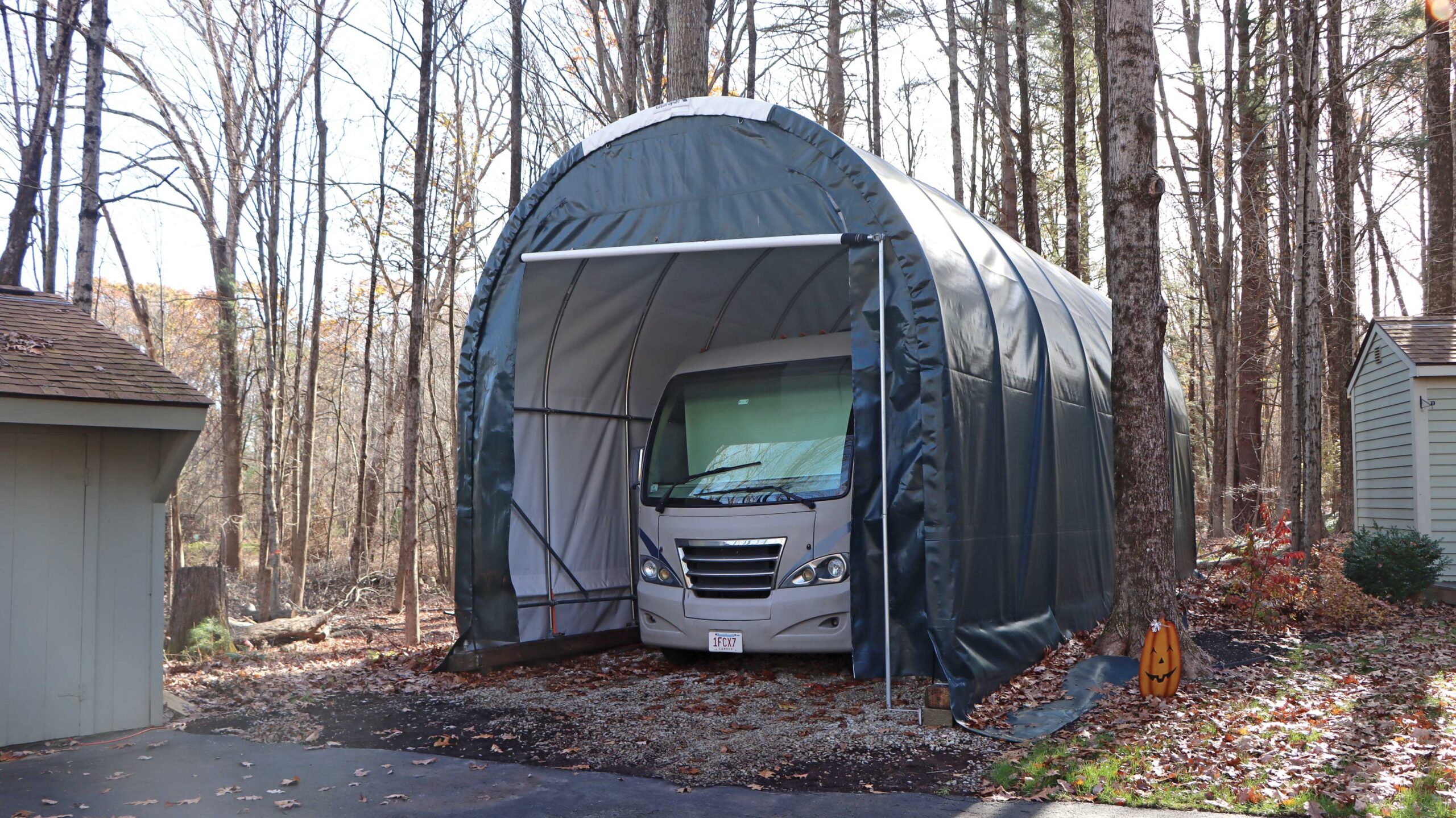 RV carport being used on border of tree line