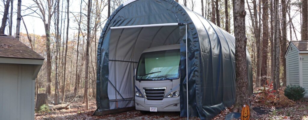 RV carport being used on border of tree line