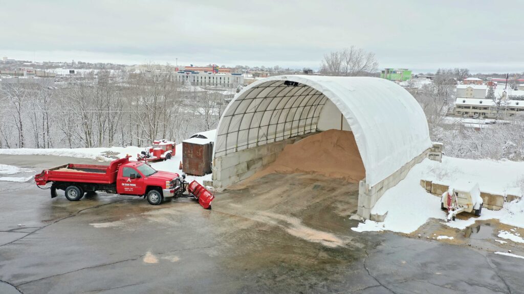 bulk material supply being stored under fabric hoop building