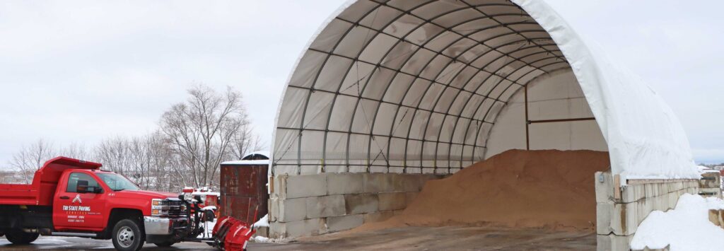bulk material supply being stored under fabric quonset hut building