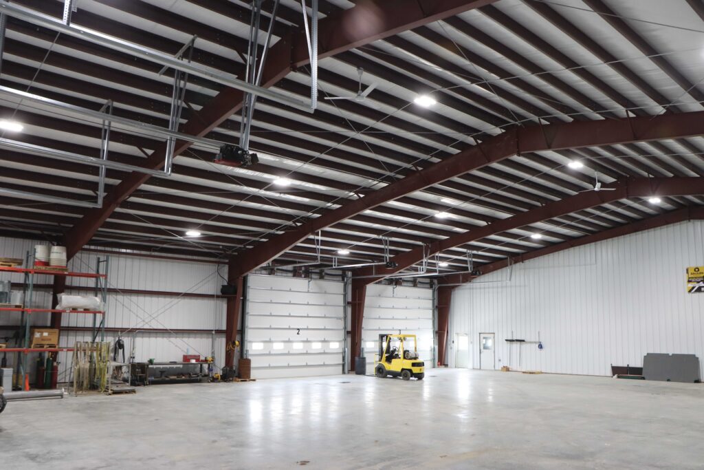 interior of a metal building with a garage door