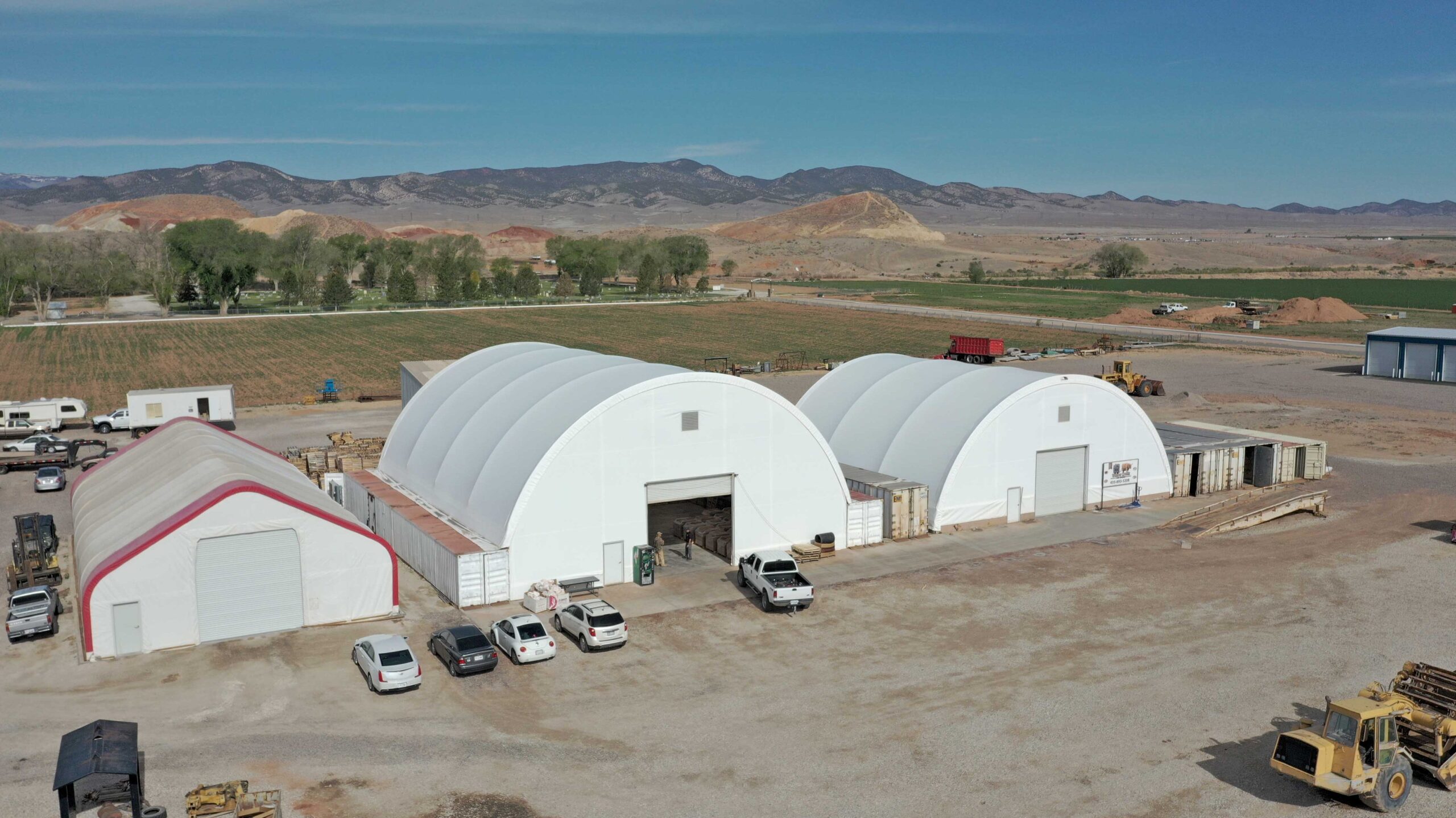 fabric container buildings with mountains in the background